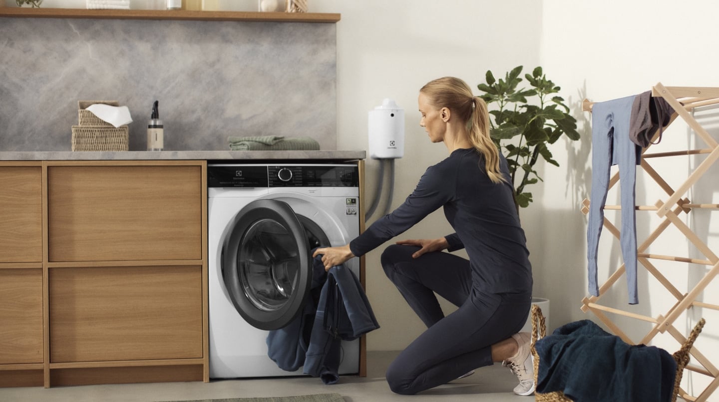 Woman loading an Electrolux washing machine